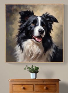 a painting of a black and white dog is hanging on the wall above a dresser