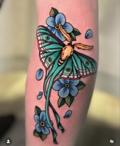 a woman's leg with a butterfly tattoo on it