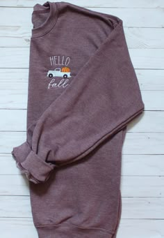 "This super comfy crewneck sweatshirt is perfect for fall weather! The light blue pumpkin truck is embroidered on the left chest with the words \"hello fall\" in white thread. This is a heather maroon adult unisex sweatshirts and is 40% cotton, 60% polyester. Please see size chart to determine the best size. This listing is for 1 sweatshirt. Are you looking for an item that is not listed? Please send me a message and let's see if we can create your item! Thank you for browsing my shop! Find us o Fall Sweatshirt Vinyl, Fall Embroidered Sweatshirts, Cute Sweatshirt Designs, Fall Sweatshirt Ideas, Autumn Sweatshirts, Etsy Sweatshirts, Fall Cricut, Fall Crewneck Sweatshirt, Embroidery Shirts