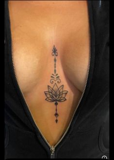 a woman's chest with a tattoo on her left side and an arrow in the middle