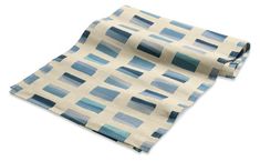 a blue and white scarf on top of a white surface with an image of squares