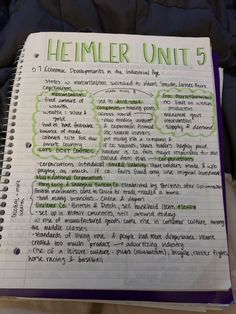 a note book with writing on it in front of a black jacket that says heimer unit 5