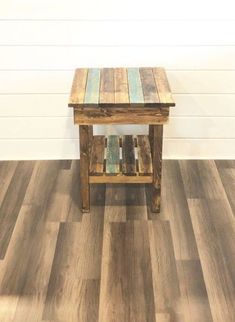 a small wooden table sitting on top of a hard wood floor