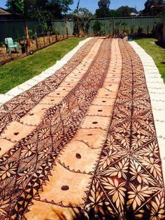 an intricately designed walkway in the middle of a yard