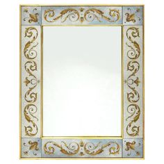 an ornate gold and blue mirror on a white wall