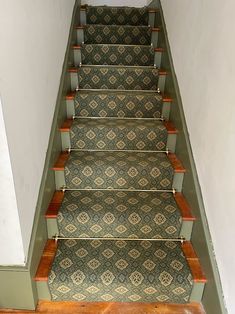 A traditional staircase adorned with a classic geometric-patterned stair runner, held in place by brass rods, offering a blend of tradition and modernity. Carpet Runner On Stairs Victorian, Brass Stair Rods Carpet Runner, Stair Runner Carpet Uk, Stark Carpet Stair Runner, Patterned Stair Carpet Lowe's, Site Visit, Stair Runner Carpet, Stair Runner