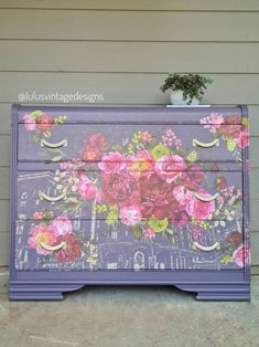 an old dresser painted with flowers on it