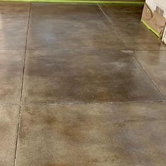 an empty concrete floor in front of a house