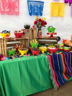 a table topped with lots of colorful plates and bowls