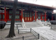 an old building with red doors and stairs