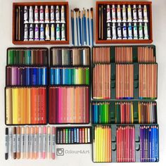 many different colored crayons in wooden boxes