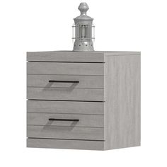 a grey wooden dresser with three drawers and a light on top of the drawer, in front of a white background