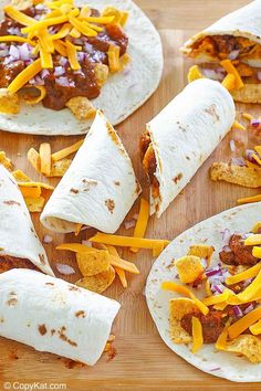 tortillas filled with meat and cheese on a cutting board