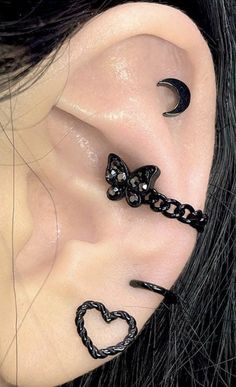 the ear is decorated with black beads and a heart