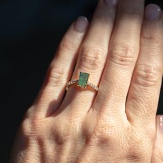 Give your style a sparkle with our Classic Prong Hidden Halo Sapphire solitaire with French Set diamond band. A 1.67ct emerald cut, opalescent green sapphire is at its center, measuring around 8x5mm. Its unique profile elevates your style and makes it easy to mix and match with similar bands. Crafted from recycled 18k yellow gold and decorated with delicate tapered, natural diamonds from 1.3mm to 2mm in size, this beauty will make a statement. Finish off your look with either a classic polished Luxury Emerald Cut Ring With Gemstone Accents, Luxury Radiant Cut May Birthstone Jewelry, Emerald Jewelry With Radiant Cut Accent Stones, Radiant Cut Emerald Jewelry With Accent Stones, Green Moissanite Jewelry In Radiant Cut, Green Moissanite Jewelry With Radiant Cut, Green Moissanite Radiant Cut Jewelry, Green Radiant Cut Moissanite Jewelry, Fine Jewelry Emerald Cut Tsavorite