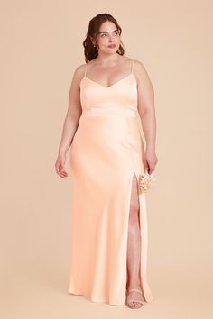 a woman in a long peach dress