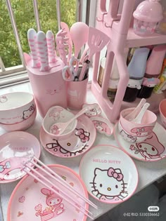 hello kitty dishes and utensils on a counter