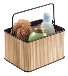 a wooden basket with two bottles and a brush