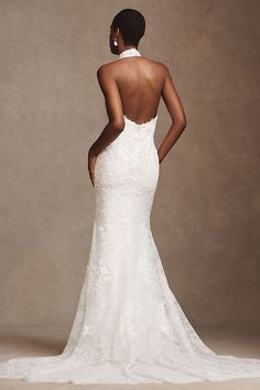 a woman in a wedding dress looking back