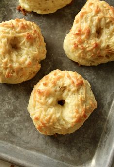 four biscuits sitting on top of a baking sheet