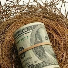 a roll of money wrapped in twine on top of a pile of hay with words written below it