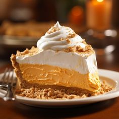 a slice of pumpkin pie on a plate with a fork and candle in the background