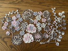 a bunch of paper flowers sitting on top of a wooden table