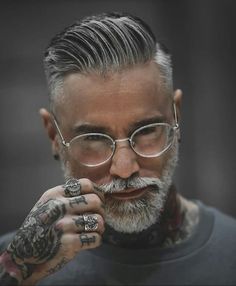 a man with tattoos and glasses on his face