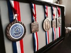 a group of medals hanging on a wall