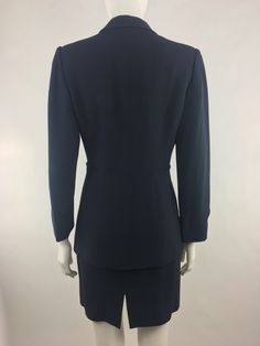 "Vintage 1990's Cheap & Chic by Moschino dark navy blue two piece suit (blazer and skirt) has a classic cut and minimalist design that makes it an excellent choice for a job interview or for the office. The navy blue blazer has lapels; long sleeves; light interior shoulder padding front single button closure; and interior lining. The matching navy blue skirt has a back zipper closure and back vent in the center near the lower hem. Made in Italy Garment has been pinned to mannequin to illustr Vintage Navy Blazer For Workwear, Vintage Notch Lapel Skirt Suit For Office, Suit Graduation, Navy Fitted Vintage Blazer, Blue Vintage Blazer With Lapel Collar, Luxury Vintage Blue Blazer, Graduation Suit, Interview Suits, Office Suit