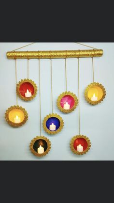 a group of candles hanging from a metal rod