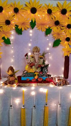 there is a gandap decorated with sunflowers and candles on the table