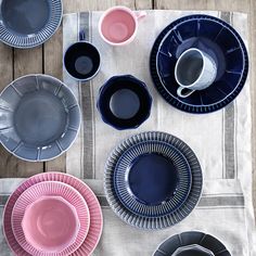 a table topped with lots of plates and cups