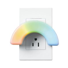 a rainbow colored light switch cover on a white wall with an electrical outlet in the middle