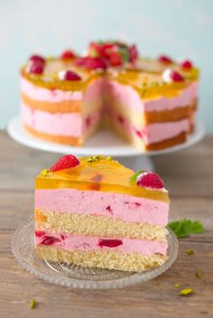 a piece of cake with raspberries on top