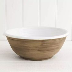 a white and brown bowl sitting on top of a table