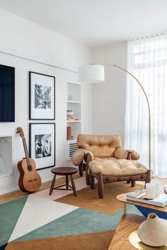 a living room filled with furniture and pictures on the wall