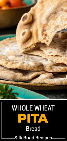 whole wheat pita bread on a plate with fruit in the background and text overlay that reads whole wheat pita bread