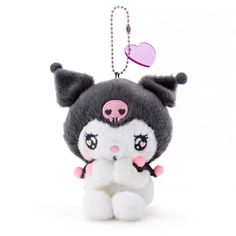 a small stuffed animal hanging from a keychain with a heart on it's back