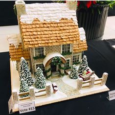 a gingerbread house with snow on the roof