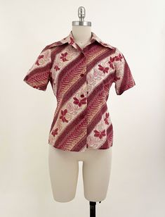 "Vintage batik women's button down shirt with large angled chest pockets. Deep reddish pink tropical floral design over gauzy cotton fabric. Has some minor discoloration - please see photos. Looks great overall. All measurements are taken with the garment laying flat and doubled for the bust, waist, and hips. Bust: 35\" Shoulder to Shoulder: 13.75\" Length (center back collar seam to hem): 23\" Label: None Material: Cotton Size on Tag: N/A Approx. Fit: XS/S Some garments have been adjusted in ph Horse Vintage, Pink Hibiscus, Pink Tropical, Women's Button Down Shirt, Floor Length Gown, Button Down Blouse, Tropical Floral, Boho Blouses, Embroidered Blouse