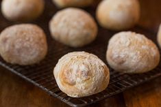 several rolls on a cooling rack ready to be baked