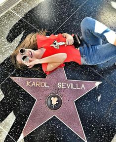 a woman laying on the hollywood walk of fame