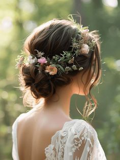 a woman with flowers in her hair wearing a white dress and holding a flower crown