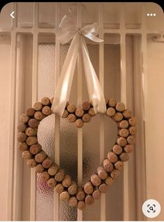 a heart shaped wreath made out of wine corks