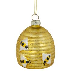 a yellow glass ornament with bees on it