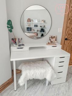 a white desk with a mirror on it and a stool in front of the table