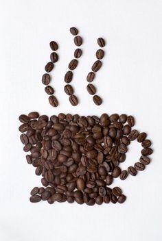 coffee beans falling out of a cup