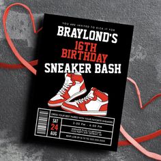 a birthday card with a pair of sneakers on it and a red ribbon around the bottom