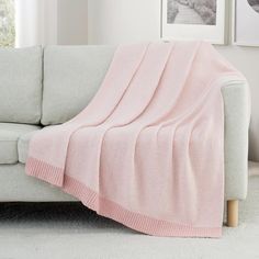 a couch with a pink blanket on top of it